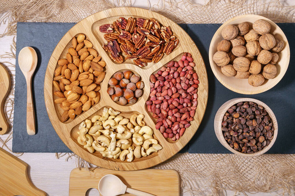 Mix of nuts top view. Walnuts, cashew, almond, pecan, hazelnut, peanuts Healthy various super food selection - Photo, Image