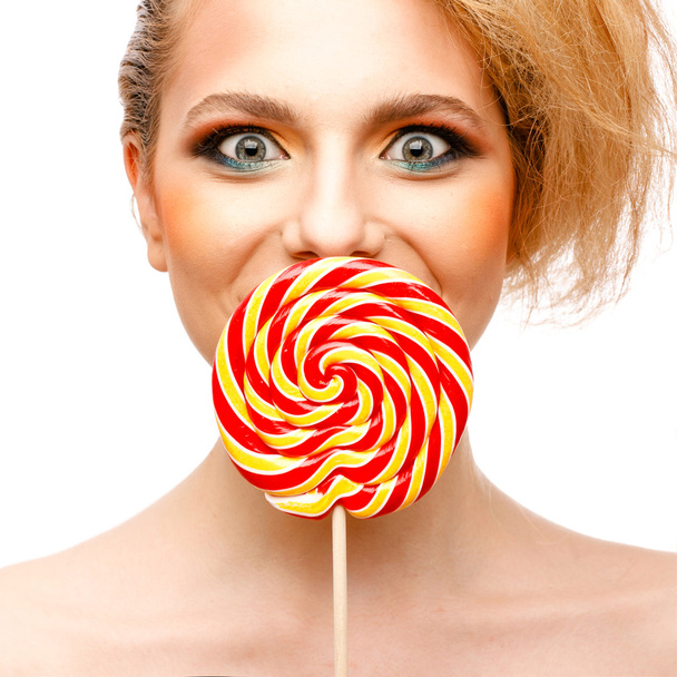 woman licks candy with beautiful make-up isolated on white background - Foto, Bild