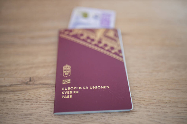 European Union, Sweden Passport with a 20 Swedish Kronor Banknote Inside - Foto, immagini