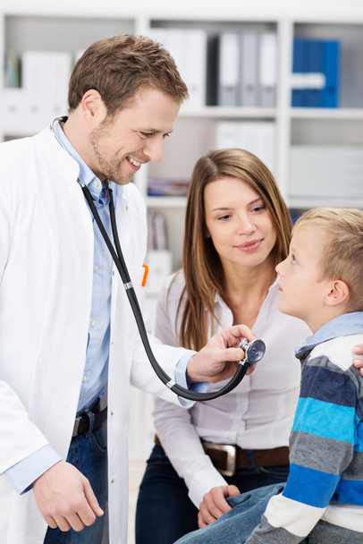 Young male doctor examining a little boy - Фото, зображення