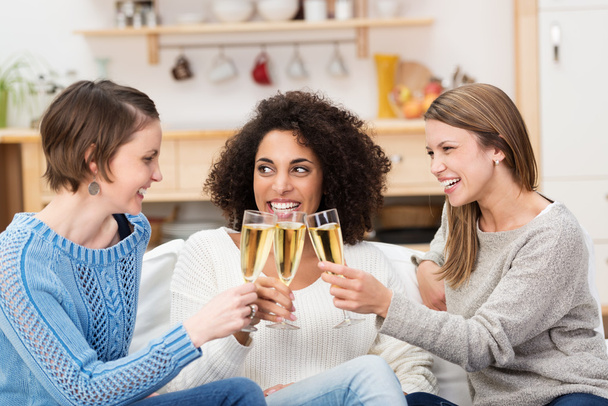 Three attractive women celebrating with champagne - Foto, Imagem