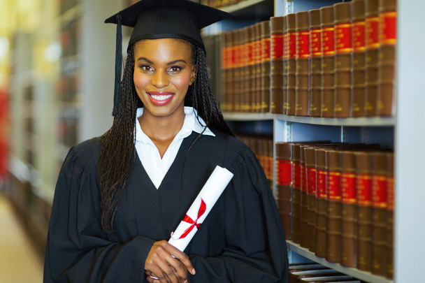 Student with diploma wearing graduation attire - Photo, image