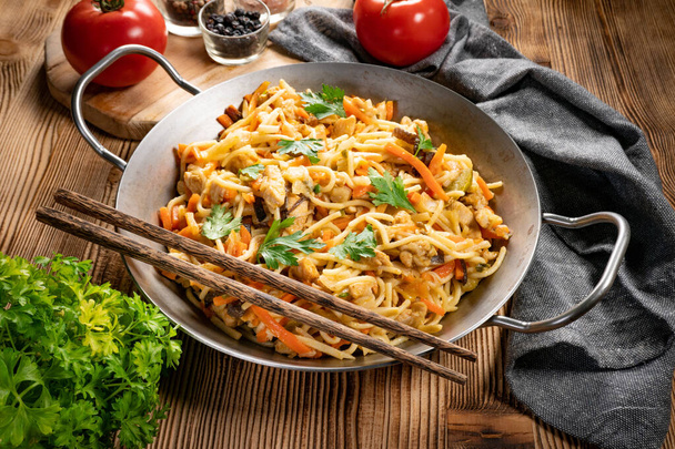 Fried noodles with chicken and vegetables. Chicken chow mein. - Фото, зображення