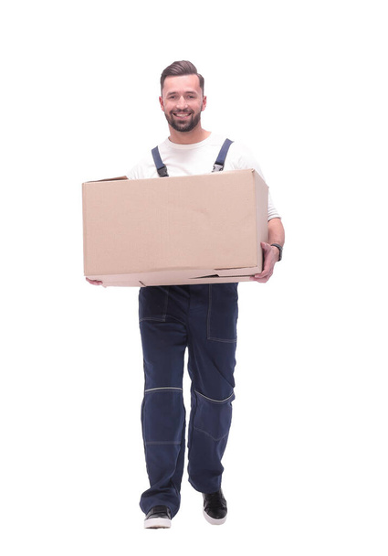 in full growth. smiling man carries a large cardboard box - Zdjęcie, obraz