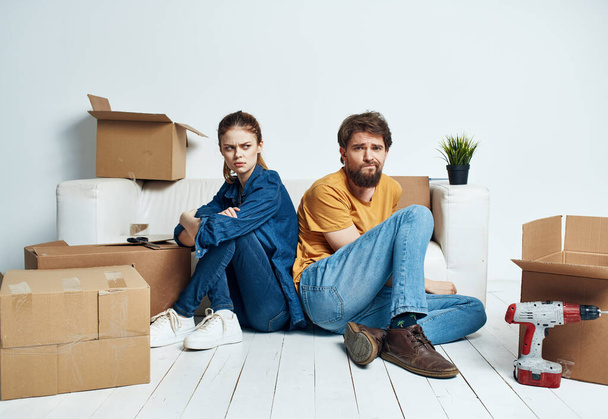 Man and woman with boxes moving wooden fully model - Photo, Image