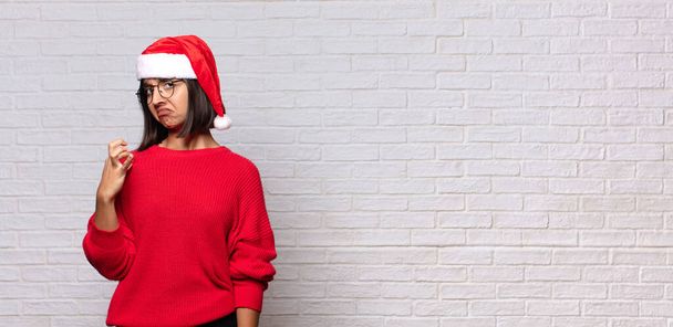 pretty woman with santa hat. christmas concept - Photo, image