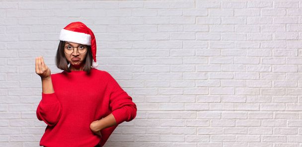 pretty woman with santa hat. christmas concept - Foto, afbeelding