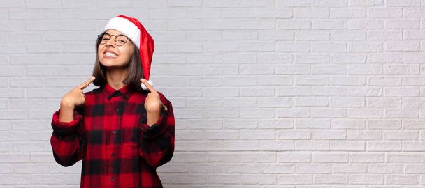 pretty woman with santa hat. christmas concept - Foto, afbeelding