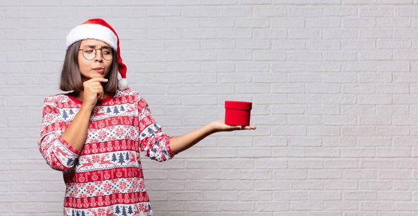 young woman christmas concept against brick wall - Foto, Imagen