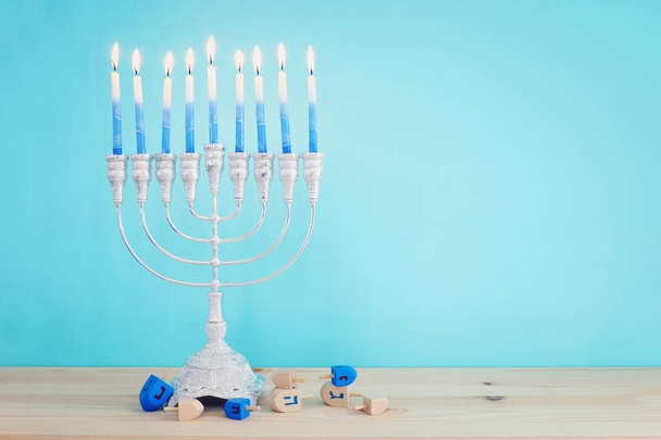 Religion image of jewish holiday Hanukkah background with menorah (traditional candelabra) and candles - 写真・画像