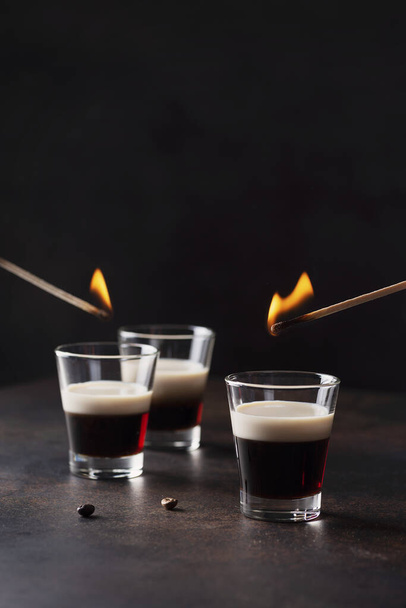 Bar concept. Coffee ligueur wit irish cream ready to set fire, selective focus image - Фото, изображение