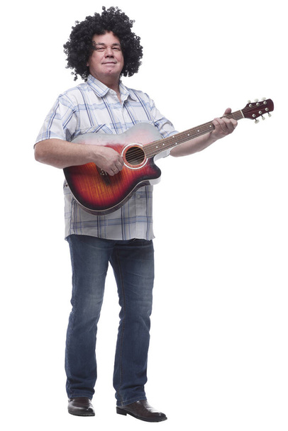 in full growth. a cheerful curly-haired man with a guitar - 写真・画像