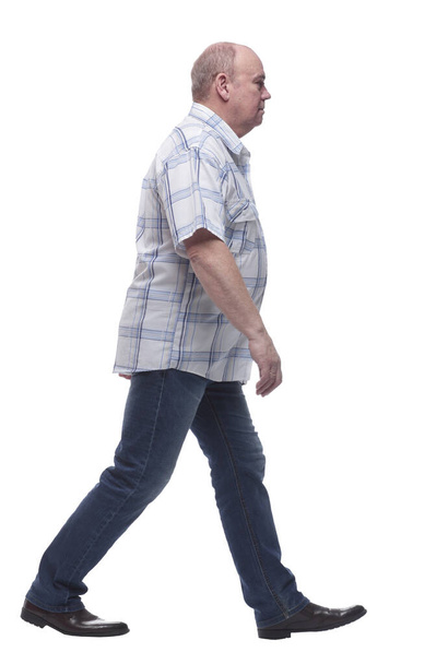side view. smiling casual man confidently striding forward - Foto, Imagen