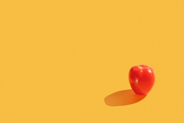 Red cherry fresh tomato on yellow background. Minimal trendy composition. Healthy organic vegan food concept. Organic farming concept  - Foto, imagen