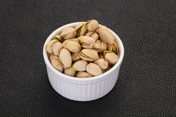 Pistachio nuts heap in the bowl - Photo, Image