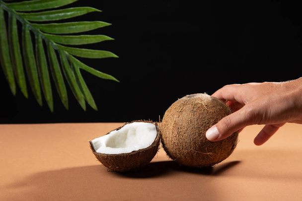 Hand holding coconut in the background. - Photo, Image