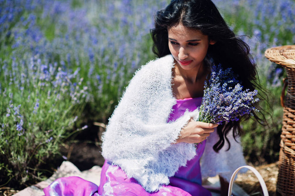 Beautiful indian girl wear saree india traditional dress in purple lavender field with basket. - Valokuva, kuva