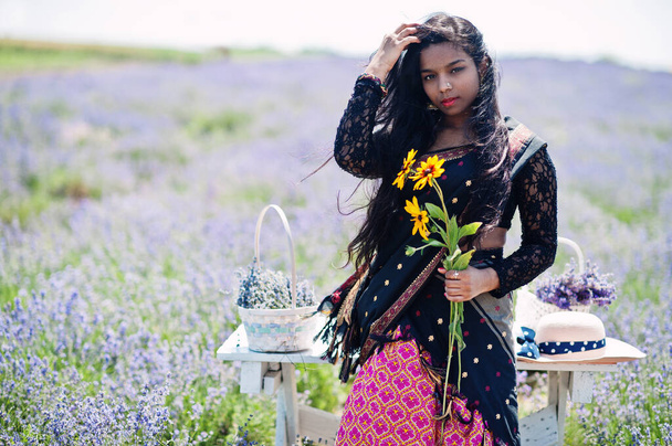Beautiful indian girl wear saree india traditional dress in purple lavender field.  - Фото, изображение