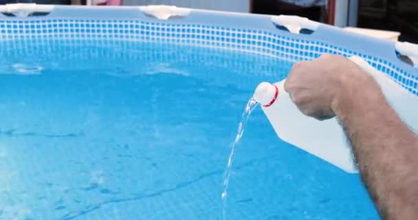 Cleaning a PVC frame pool from algae by pouring perhydrol, Concept of cleaning services - Footage, Video