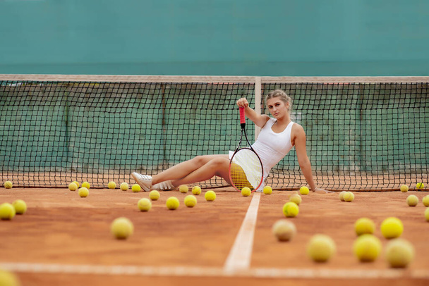 professional tennis player woman with racket and ball near net on court. - Фото, зображення