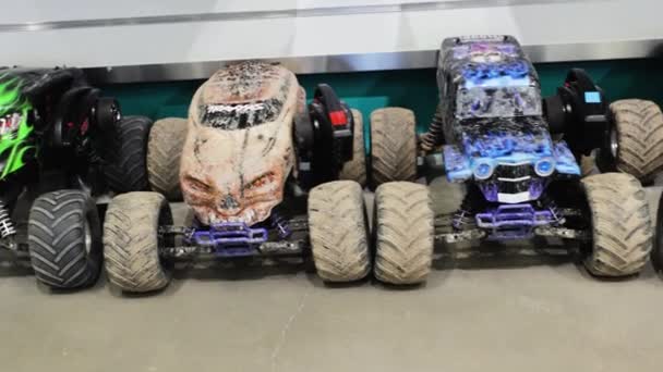 Close up view of line of colorful radio controlled toy cars dirty after racing. - Footage, Video
