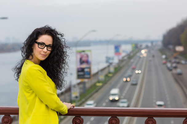 Beautiful girl is  on a bridge outdoor - Photo, Image