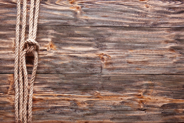 Sailor's knot over old wooden background. - Φωτογραφία, εικόνα