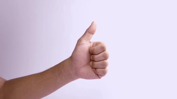 male hand giving thumbs up on a white background. Thumb up hand sign isolated. - Footage, Video
