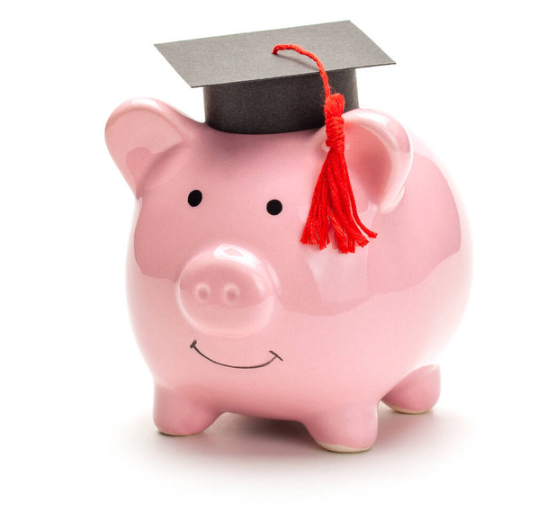 Piggy bank and black graduate hat isolated on white  - Photo, Image