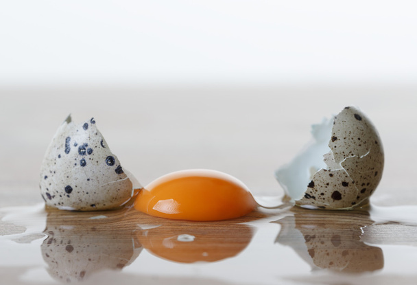 Quail egg broken on the table - Foto, immagini