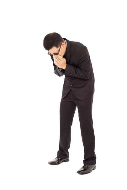 Geschäftsmann niest mit gebeugtem Körper - Foto, Bild