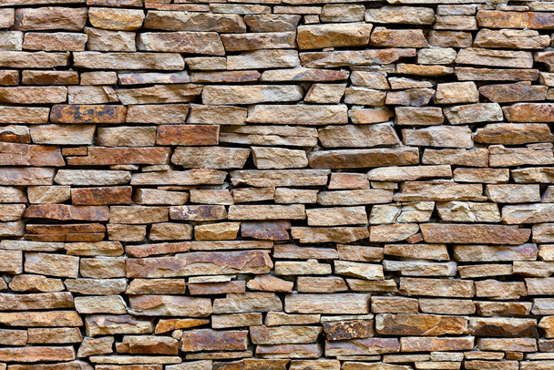 Part of a sandstone stone wall, expressive texture and background in high resolution. - Foto, immagini