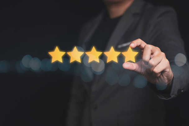 Customer satisfaction in product and service concept , Businessman putting golden five star for evaluation after received service. - Φωτογραφία, εικόνα
