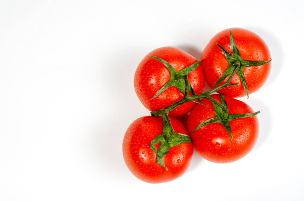 group of several red tomatoes with moisture drops isolated on white background - Foto, imagen