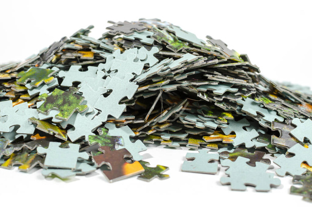 Pieces of a multicolored puzzle lie chaotically in a large pile - Fotó, kép