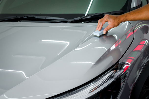 mechanic is coating ceramic glass to prevent scratches on cars. - Photo, image