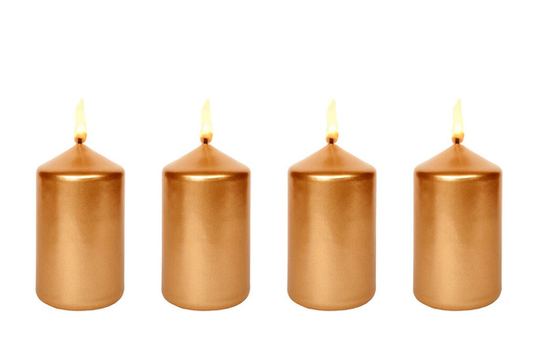 Cuatro velas doradas encendidas, aisladas frente al fondo blanco - Foto, Imagen