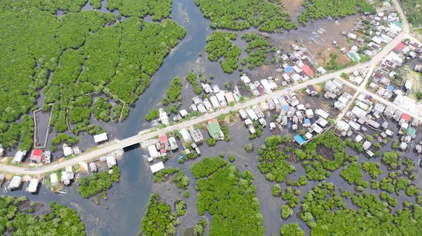 Concrete road and a village in the mangroves, top view. Houses on the water, Philippine village. - Foto, immagini