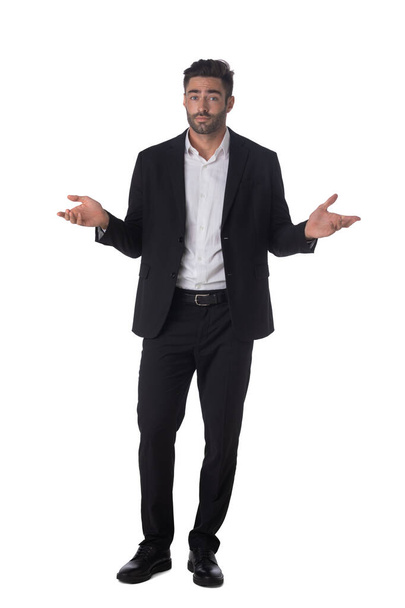 Full length portrait of confused clueless fruastrated business man shrug hands studio isolated on white background - Foto, afbeelding