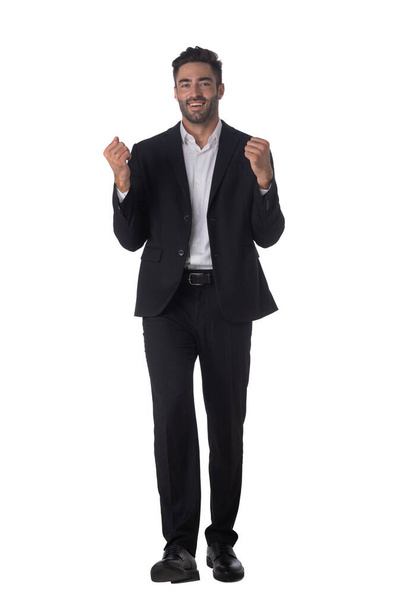 Full length portrait of successful excited happy business man in black suit looking at camera hold fist ok yes gesture studio isolated on white background - Fotografie, Obrázek