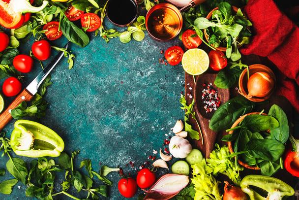 Fresh helthy food cooking vegetable ingredients on dark background with rustic wooden board. Diet or vegetarian food concept. Top view, copy space - Foto, Bild