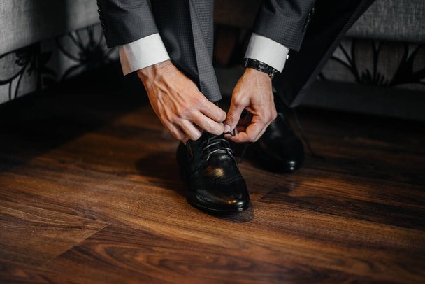 A man is wearing black shoes in close-up. - Fotó, kép
