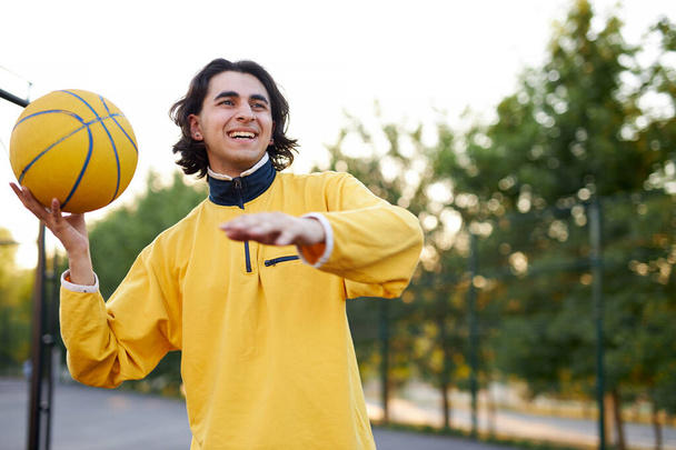 portrait of long haired caucasian teen boy with ball - Фото, изображение