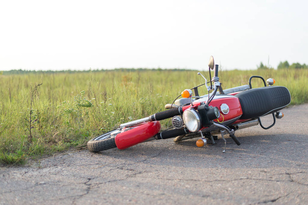 Photo red motorcycle on road, the concept of road accidents - Photo, Image