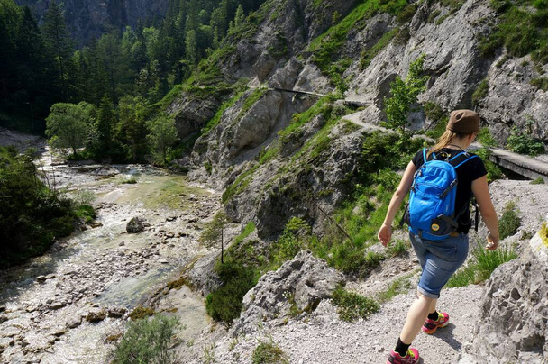 Wonderful day for Hiking: Young sporty woman hiking on beautiful trail in the Oetschergraben in Lower Austria / Spectacular canyon next to Mount Oetscher  - Фото, изображение
