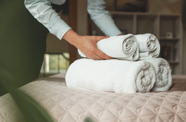 Room service. Woman changing towels in hotel room. - Fotoğraf, Görsel