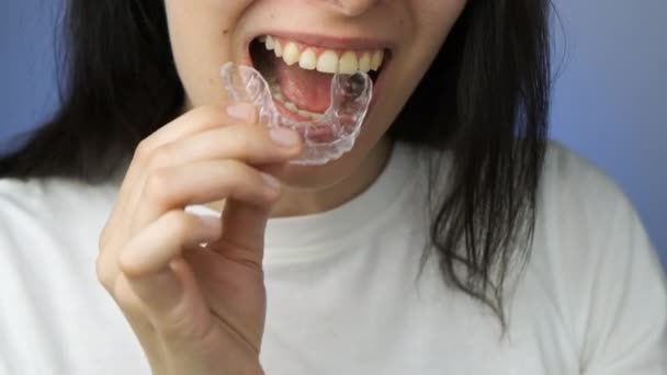 Woman is inserting removable braces or aligner. - Footage, Video