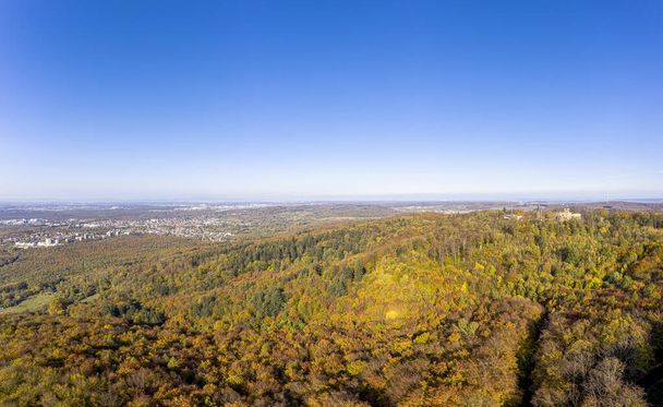Drone photo of Frankenstein Castle near Darmstadt in Germany with a view over the Rhine-Main area during the day in autumn - Fotó, kép