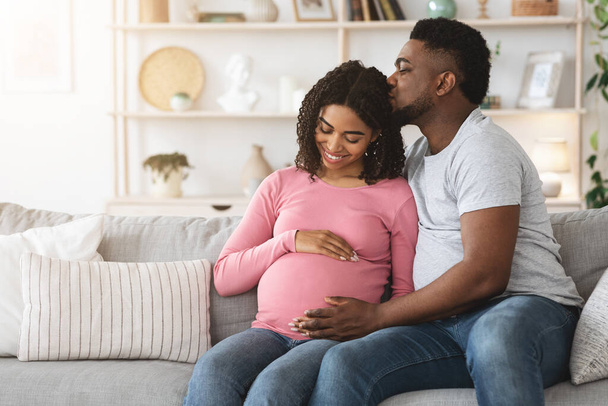 Happy pregnant african american enjoying time together - Photo, Image