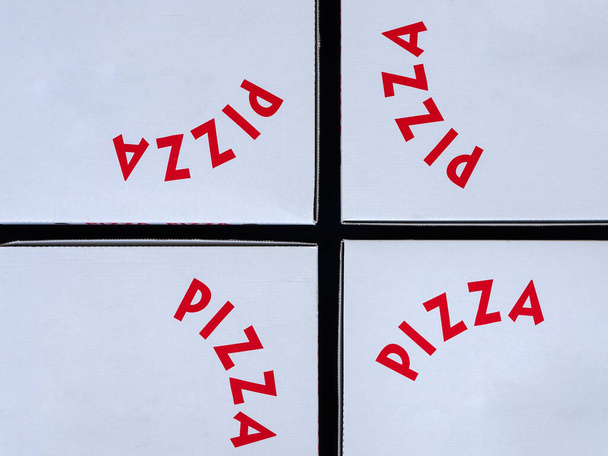 赤い文字を持つ4つの白いピザボックス。持ち帰り用のコンセプト - 写真・画像